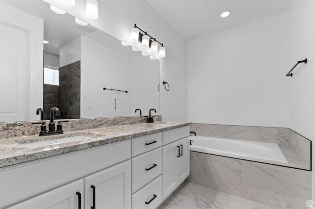 bathroom featuring vanity and separate shower and tub