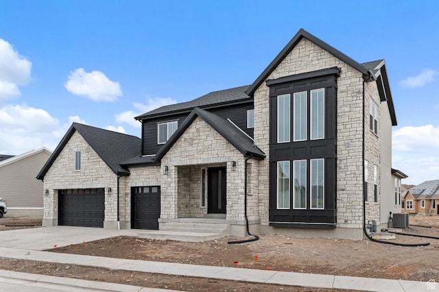 view of front of home with central AC and a garage