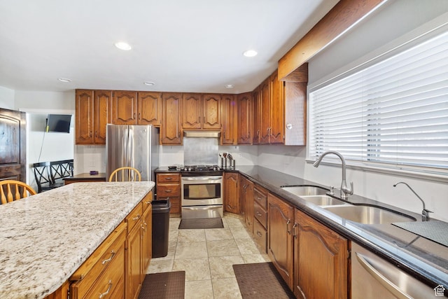 1975 Laguna Vista Dr, Orem, UT 84058 - kitchen with light stone countertops, appliances with stainless steel finishes, sink, and light tile patterned floors