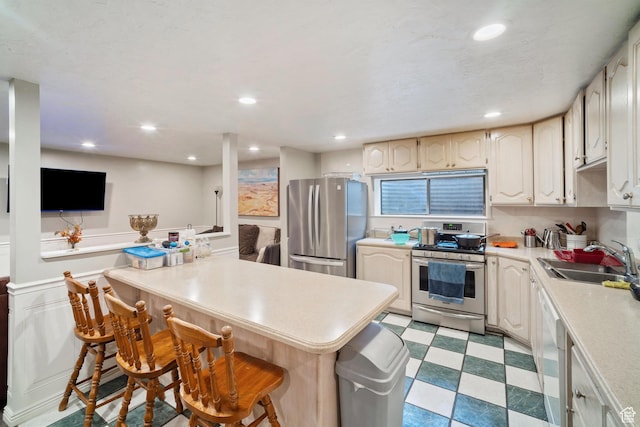 1975 Laguna Vista Dr, Orem, UT 84058 - kitchen with sink, a breakfast bar, and appliances with stainless steel finishes