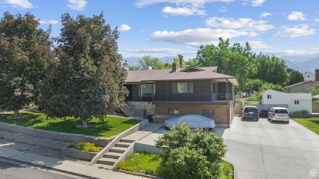 1975 Laguna Vista Dr, Orem, UT 84058 - view of front of property with stairs, a mountain view, brick siding, and a chimney