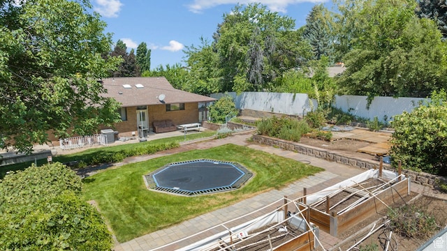 1975 Laguna Vista Dr, Orem, UT 84058 - view of yard featuring a trampoline, a vegetable garden, and a patio
