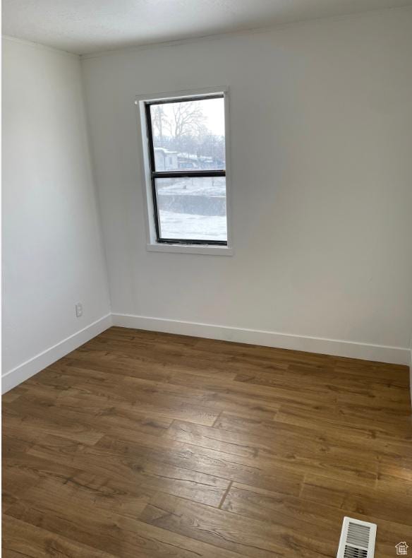 spare room featuring dark hardwood / wood-style flooring