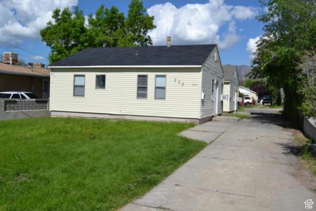 view of side of home with a yard