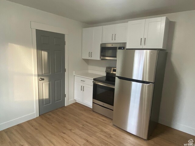 458 E Lambourne Ave, Salt Lake City, UT 84115 - kitchen with stainless steel appliances, white cabinetry, and light wood-type flooring