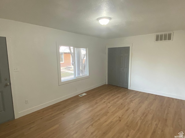 458 E Lambourne Ave, Salt Lake City, UT 84115 - unfurnished room with a textured ceiling and light hardwood / wood-style flooring