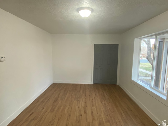 458 E Lambourne Ave, Salt Lake City, UT 84115 - unfurnished room featuring wood-type flooring and a textured ceiling