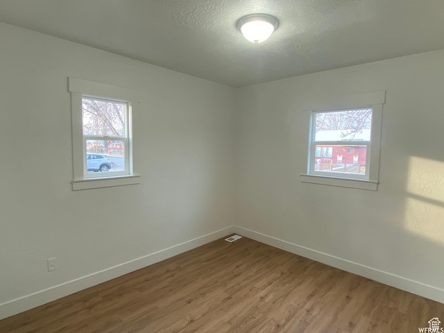 458 E Lambourne Ave, Salt Lake City, UT 84115 - unfurnished room featuring a textured ceiling and light wood-type flooring