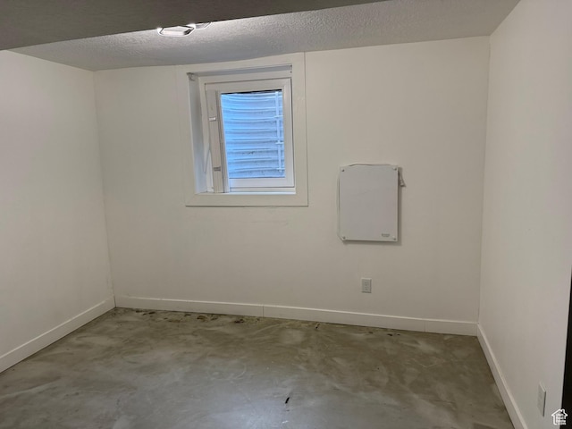 spare room featuring a textured ceiling