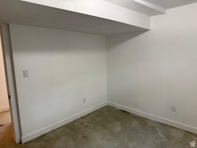 empty room featuring concrete flooring and a textured ceiling