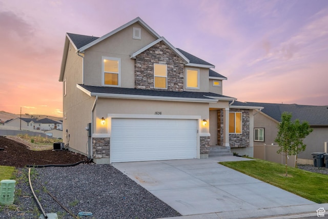 1636 W Onyx Dr Unit 217, Santaquin, UT 84655 - view of front facade featuring stone siding, stucco siding, driveway, and a garage
