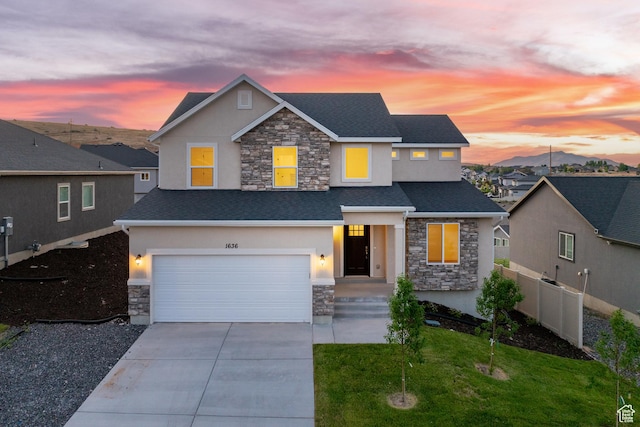 1636 W Onyx Dr Unit 217, Santaquin, UT 84655 - view of front of property with stone siding, stucco siding, a garage, driveway, and roof with shingles