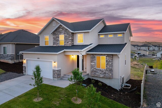 1636 W Onyx Dr Unit 217, Santaquin, UT 84655 - view of front of property featuring stone siding, stucco siding, driveway, and a garage
