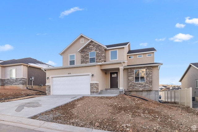 view of front facade with driveway, a garage, stone siding, fence, and stucco siding