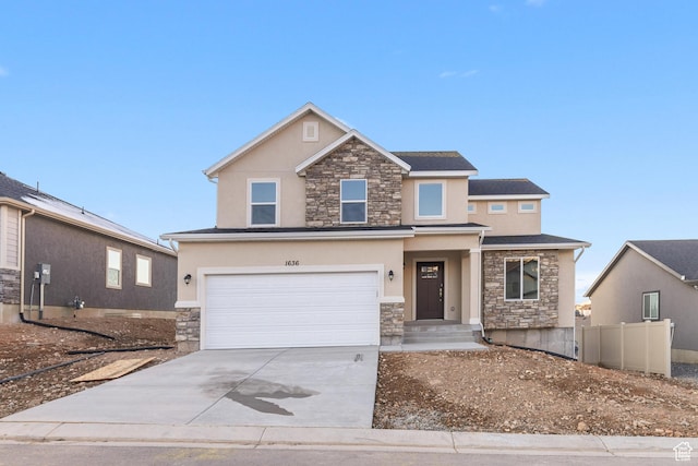 view of front of house featuring stone siding, concrete driveway, and stucco siding