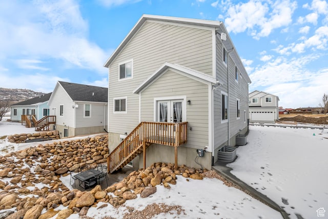156 E Sailors Way Unit 11, Garden City, UT 84028 - snow covered back of property with a garage and cooling unit
