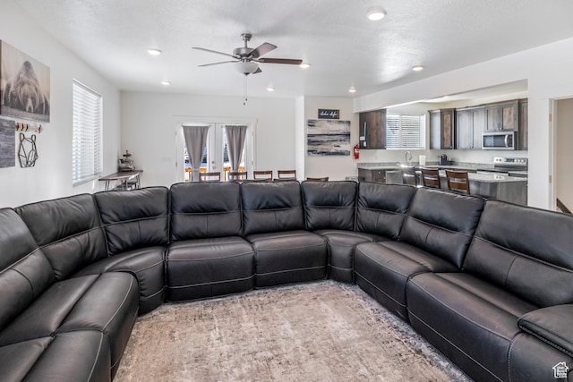 156 E Sailors Way Unit 11, Garden City, UT 84028 - living room with a textured ceiling, ceiling fan, and french doors