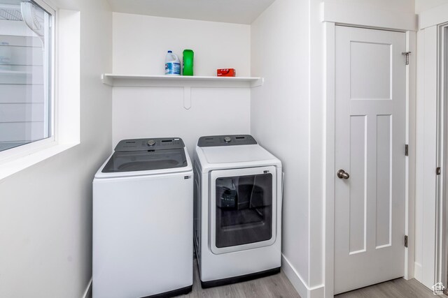 156 E Sailors Way Unit 11, Garden City, UT 84028 - washroom featuring washer and dryer and light hardwood / wood-style flooring