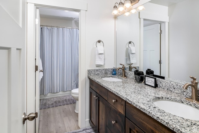 156 E Sailors Way Unit 11, Garden City, UT 84028 - bathroom featuring hardwood / wood-style flooring, vanity, toilet, and walk in shower
