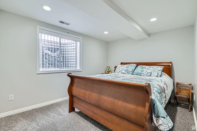 carpeted bedroom with beamed ceiling