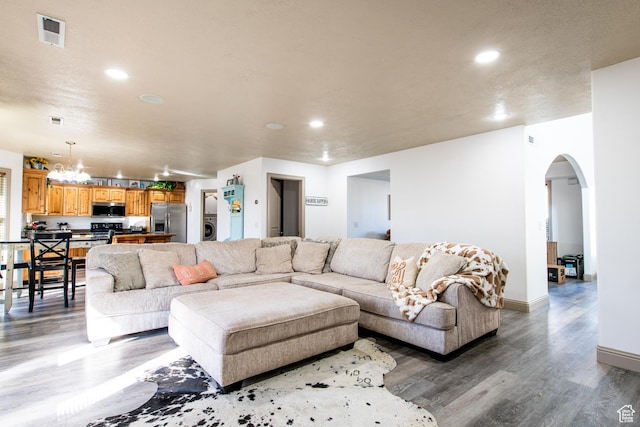 living room with hardwood / wood-style floors and washer / dryer