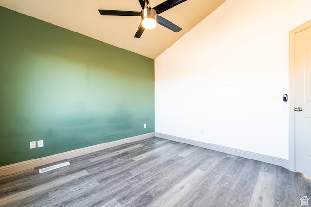 spare room with ceiling fan, lofted ceiling, and hardwood / wood-style floors