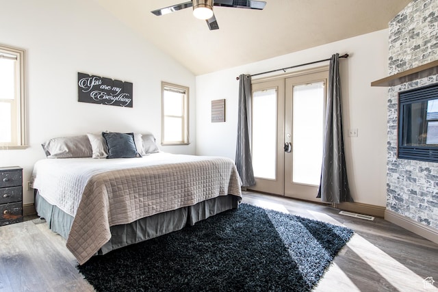 bedroom with french doors, ceiling fan, lofted ceiling, and hardwood / wood-style floors