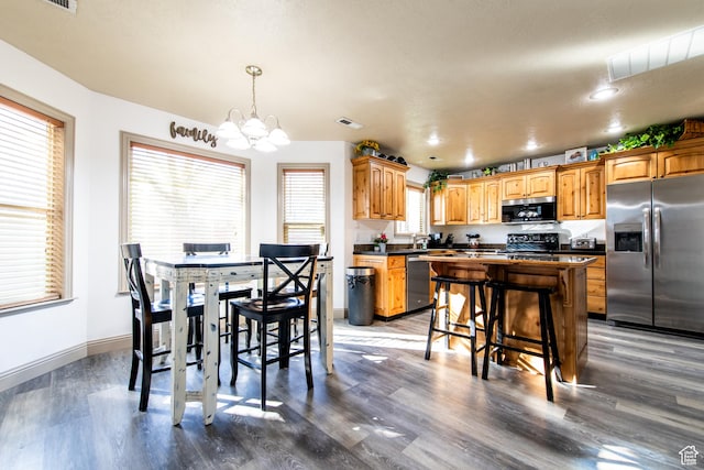 dining space with wood-type flooring and a chandelier