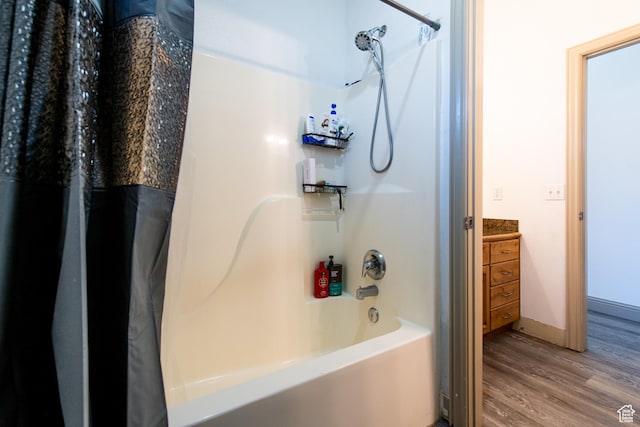 bathroom featuring vanity, hardwood / wood-style floors, and shower / bath combo