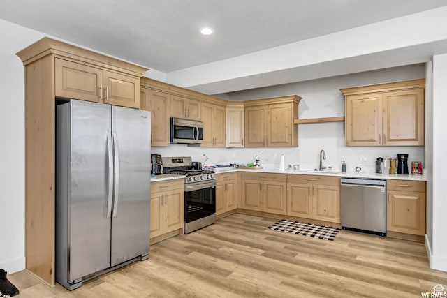 4024 W 2875 N, Plain City, UT 84404 - kitchen with appliances with stainless steel finishes, light brown cabinets, a sink, light countertops, and light wood-type flooring