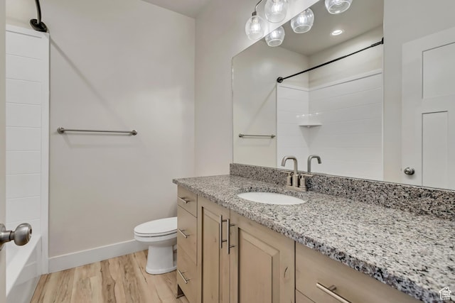 4024 W 2875 N, Plain City, UT 84404 - bathroom with wood finished floors, baseboards, toilet, vanity, and shower / tub combination
