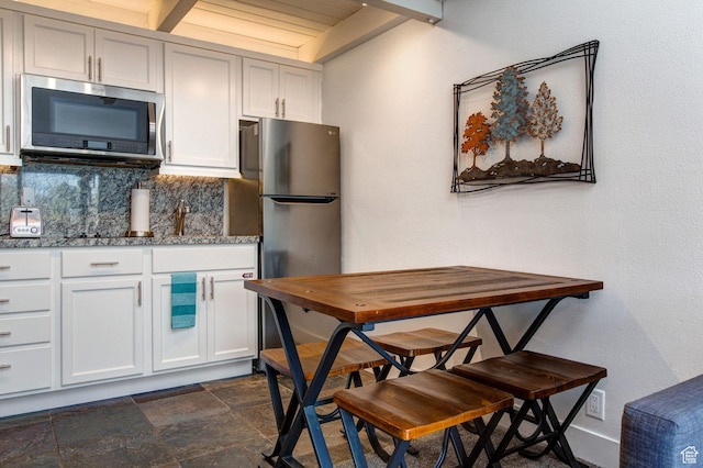 2325 Sidewinder Dr Unit 821, Park City, UT 84060 - kitchen with tasteful backsplash, stainless steel appliances, white cabinets, and stone countertops