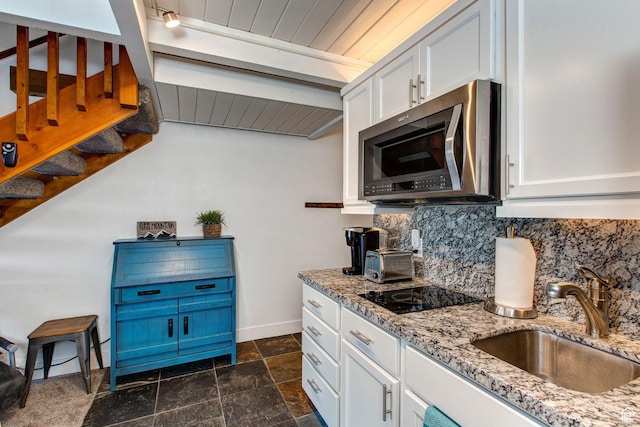 2325 Sidewinder Dr Unit 821, Park City, UT 84060 - kitchen with white cabinetry, sink, backsplash, black electric stovetop, and light stone countertops