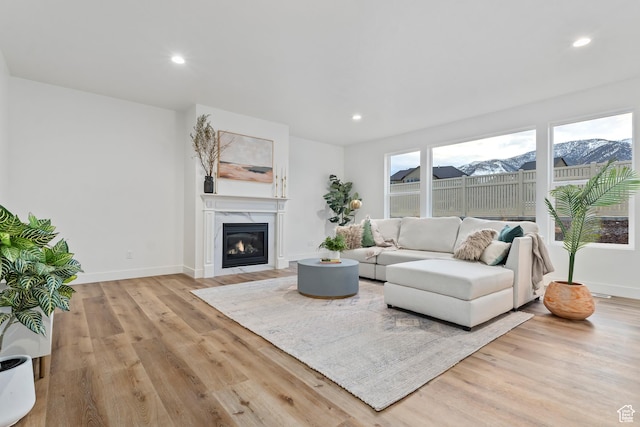 3559 S Garibaldi Way, Saratoga Springs, UT 84045 - living room featuring a fireplace, a mountain view, and light hardwood / wood-style floors