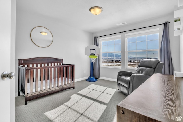 carpeted bedroom with a crib