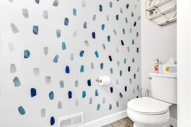 bathroom featuring hardwood / wood-style flooring, toilet, and walk in shower