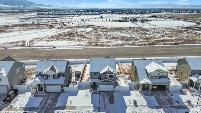 snowy aerial view with a mountain view