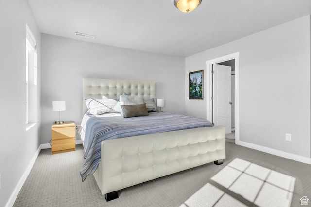 carpeted bedroom with multiple windows