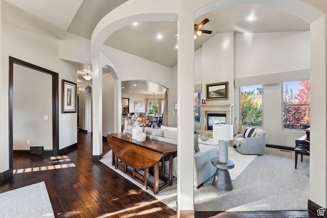 3180 E Stoney Creek Cir S, Heber City, UT 84032 - living room with ceiling fan, arched walkways, a glass covered fireplace, hardwood / wood-style flooring, and baseboards