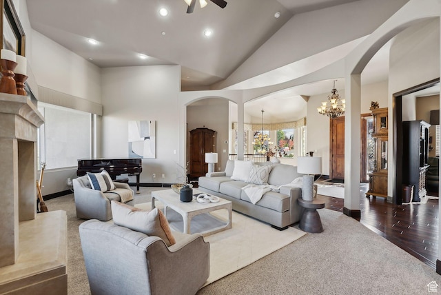 3180 E Stoney Creek Cir S, Heber City, UT 84032 - carpeted living area with arched walkways, a chandelier, ceiling fan, baseboards, and high vaulted ceiling