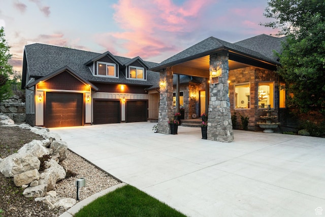 3180 E Stoney Creek Cir S, Heber City, UT 84032 - view of front of property with driveway, a shingled roof, stone siding, and an attached garage