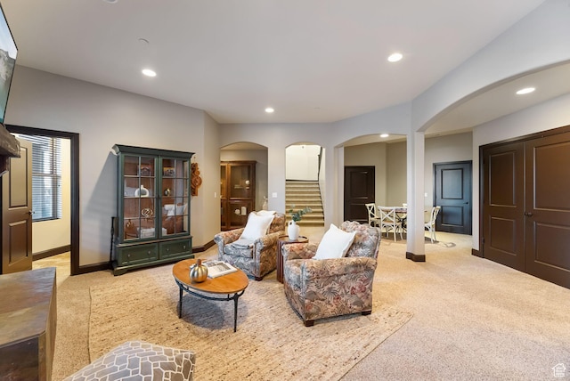 3180 E Stoney Creek Cir S, Heber City, UT 84032 - living area with arched walkways, stairs, light colored carpet, recessed lighting, and baseboards