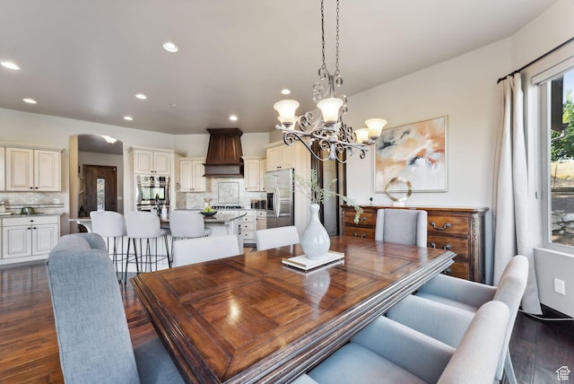 3180 E Stoney Creek Cir S, Heber City, UT 84032 - dining space with a chandelier, recessed lighting, dark wood-type flooring, and arched walkways