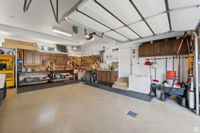 3180 E Stoney Creek Cir S, Heber City, UT 84032 - garage featuring a workshop area and a garage door opener