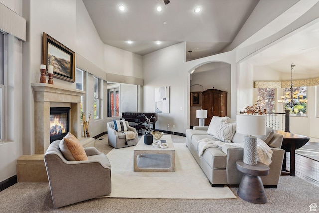 3180 E Stoney Creek Cir S, Heber City, UT 84032 - living area featuring a premium fireplace, arched walkways, recessed lighting, baseboards, and a chandelier