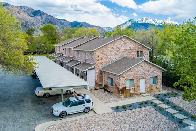110 Jefferson Ave, Ogden, UT 84404 - view of front of house with brick siding, a mountain view, and roof with shingles