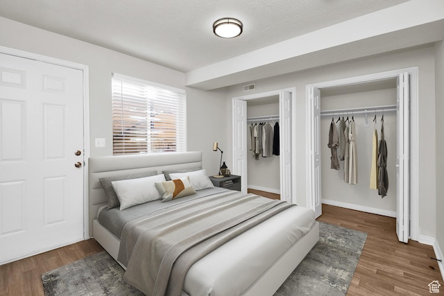 110 Jefferson Ave, Ogden, UT 84404 - bedroom with wood finished floors, multiple closets, and baseboards