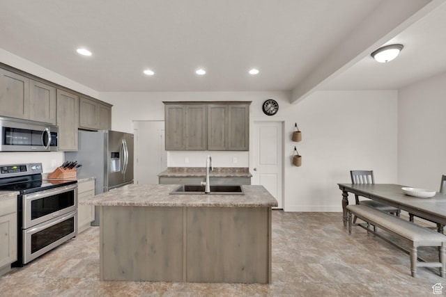 1054 S 1050 W, Tooele, UT 84074 - kitchen with appliances with stainless steel finishes, a sink, a center island with sink, recessed lighting, and baseboards