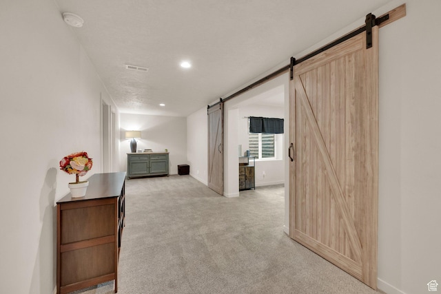 1054 S 1050 W, Tooele, UT 84074 - corridor featuring a barn door, light carpet, baseboards, and recessed lighting