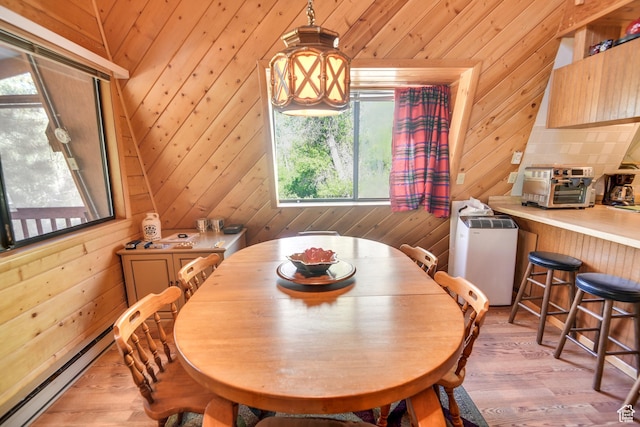 2690 E Hwy 153, Beaver, UT 84713 - dining area with a baseboard heating unit, wooden walls, and light hardwood / wood-style floors
